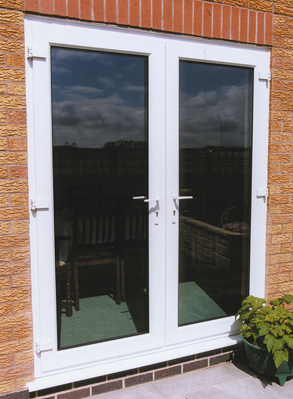 White framed French doors with large double-glazed panels opening to a patio