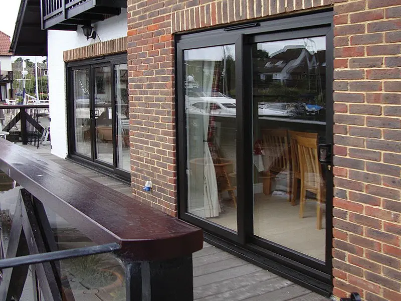Black framed patio sliding doors on a modern property