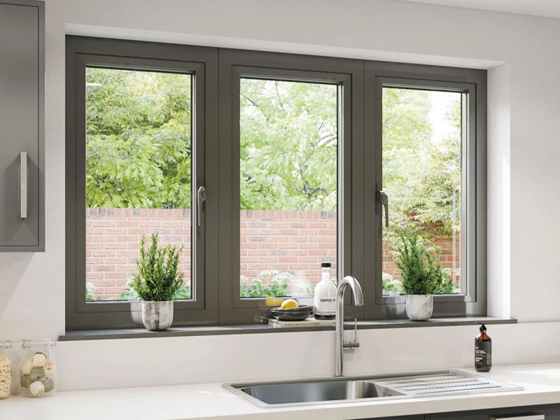 Kitchen interior with aluminium framed windows overlooking the garden