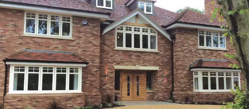 Traditional storm-profile casement window installation close-up