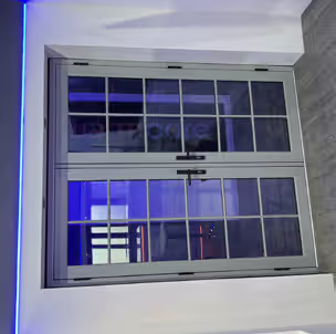 Grey framed uPVC windows with decorative glazing bars on a home exterior