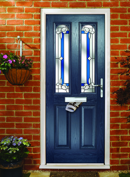 Technician assembling decorative leaded glazing on a fabrication bench
