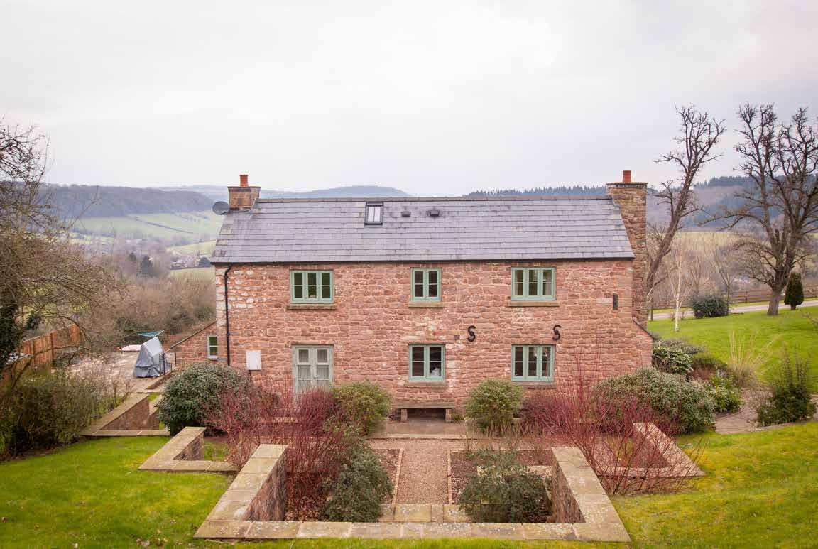 Traditional home elevation with period-style replacement windows