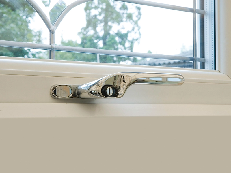 Detailed close-up of a secure window handle and locking point