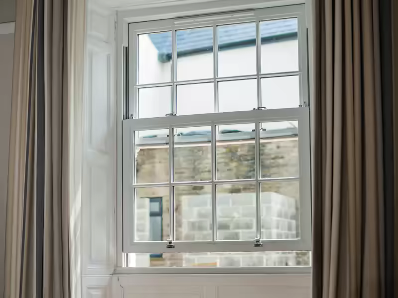 White vertical sliding sash windows on a property exterior